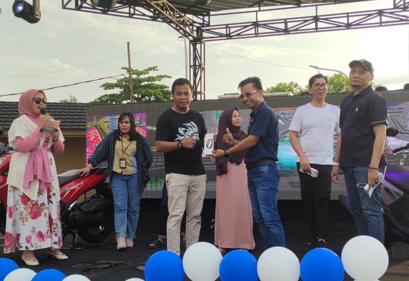 Area Manager Dealer Yamaha PT Thamrin Brothers Bengkulu, Rudios Samuel saat memberikan hadiah kepada pembeli pertama Yamaha LEXi LX 155 di Bengkulu